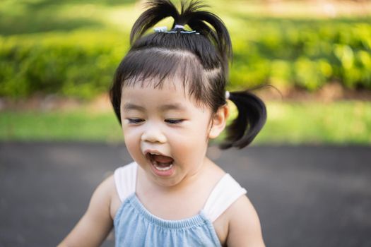 Cute baby laughing after running at the park