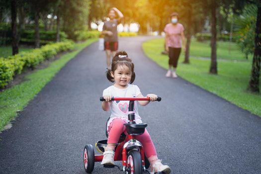 Cute children riding a bike. Kids enjoying a bicycle ride.