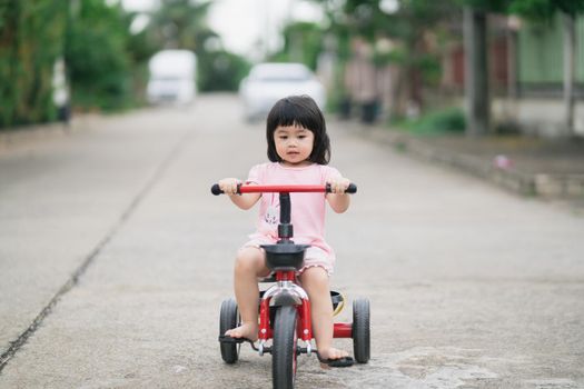 Cute children riding a bike. Kids enjoying a bicycle ride.