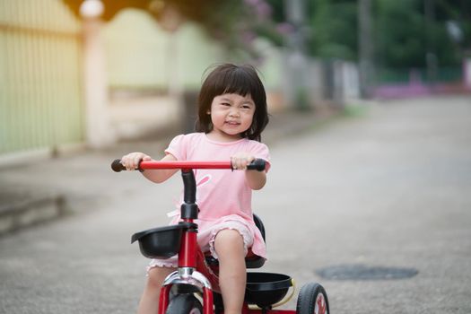 Cute children riding a bike. Kids enjoying a bicycle ride.