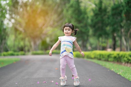 Cute baby playing and jomping at the garden, cute baby outdoor activity concept