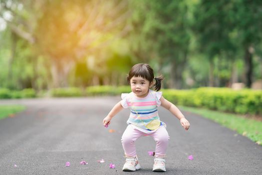 Cute baby playing and jomping at the garden, cute baby outdoor activity concept