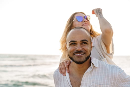 Young happy couple on seashore enjoying the sea, close up