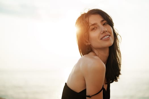 Young smiling woman outdoors portrait at the beach