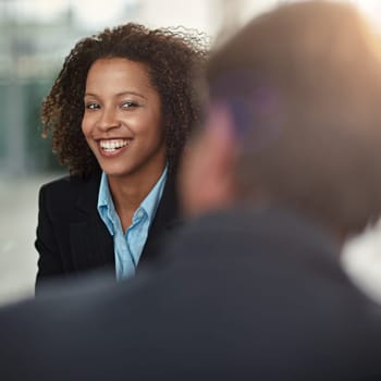 Business meeting, portrait of businesswoman smile and with colleagues at office. Corporate or consulting, happy and communication or collaboration with black female person with coworkers at workplace.