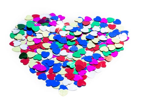 Color shiny hearts on the table for Valentine's Day. Isolated over white background