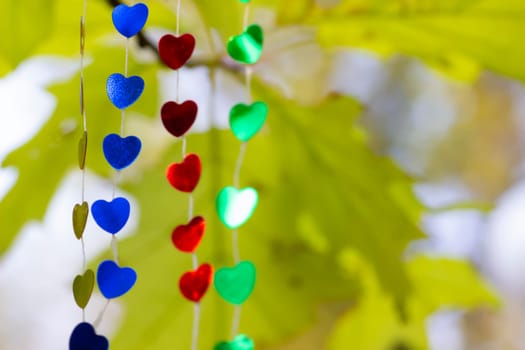 Colored shiny hearts hanging garland for Valentine's Day