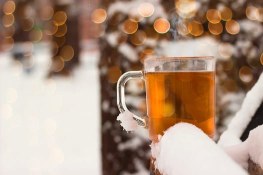 Cup with hot tea on a  snow background