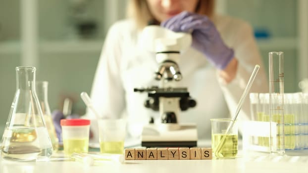 Doctor of laboratory diagnostics making general urine analysis in chemical lab closeup. Diagnosis of kidney diseases with urine test concept
