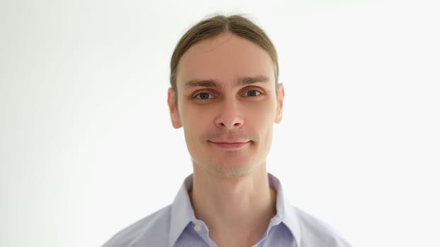 Portrait of young man in shirt on white background. Success in business concept