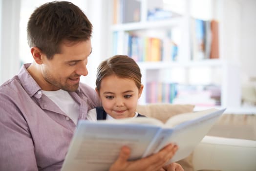 Education starts at home. a young father reading a book with his daughter