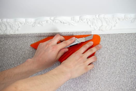 A man glues wallpaper, repairs the house. Selective focus