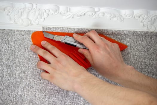 A man glues wallpaper, repairs the house. Selective focus