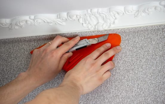 A man glues wallpaper, repairs the house. Selective focus