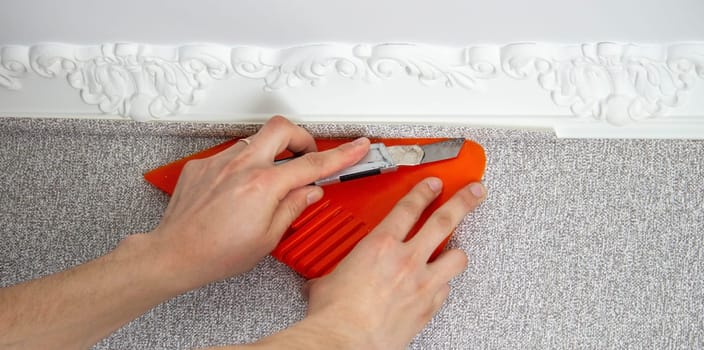 A man glues wallpaper, repairs the house. Selective focus