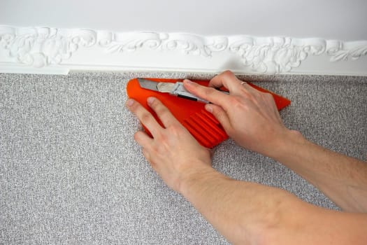 A man glues wallpaper, repairs the house. Selective focus