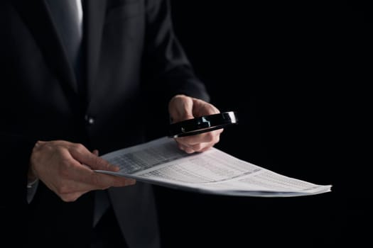 Businessman looking through a magnifying glass to contract