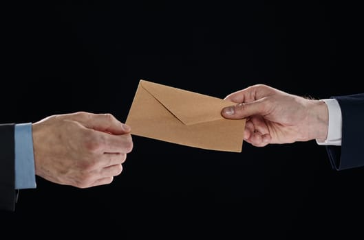 passing bribe money in the envelop at office. businessman hand taking bribe money