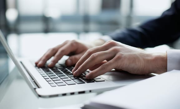 Young man working on computer at table in office, closeup. Banner design