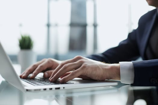 Young man working on computer at table in office, closeup. Banner design
