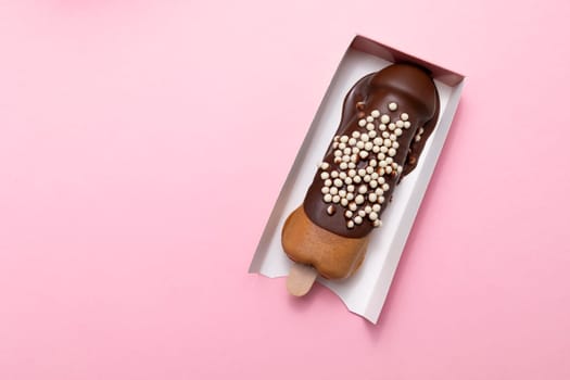 Cookie Penis Shaped Waffle On Stick Flavored With Dark Chocolate, Decorated With White Air Corn Balls In Paper Box On Pink Background. Festival Street Food. Copy Space For Text. Horizontal, Top View