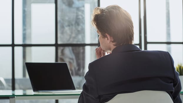 portrait businessman sitting at desk at workplace,