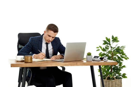 young man thinks about successful financial ideas sitting at desk