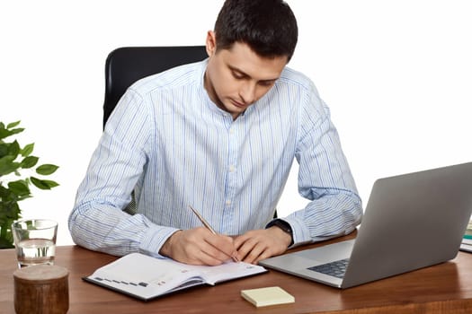 businessman in blue shirt taking notes, doing market research working in office