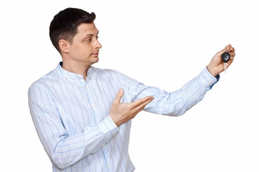 Successful caucasian businessman holding car keys on white background. Car dealerships offer car .