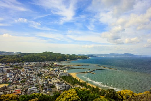 Clouds over beachfront town of Sumoto on Awaji Island on sunny day. High quality photo