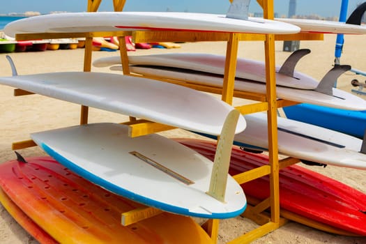 Surfboards stacked on the rack on a beach, close up