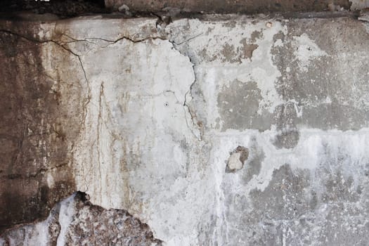 Cracks on the walls moldy. Concrete surface affected by flooding and high humidity.
