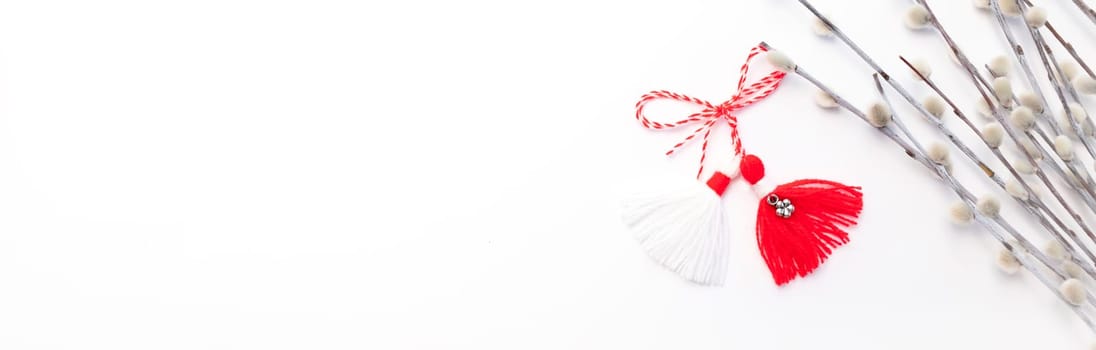 Banner Martenitsa, Baba Marta. Traditional Martisor Symbol of Holiday March 1 on White Background With Willow Twig.Grandma Marta Day Celebration In Romania,Bulgaria,Moldova. Red,white colored threads.