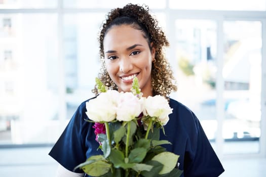 Happy, portrait and woman nurse with flowers for valentines day, romance or anniversary in the hospital. Happiness, smile and female healthcare worker with a floral bouquet of roses in the clinic