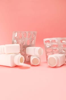 Empty plate with pills, capsule, vitamin bottles, containers on pink background. Medical, pharmaceutical business. Price, consumption concept. Medical expenses. Vertical, copy space for text