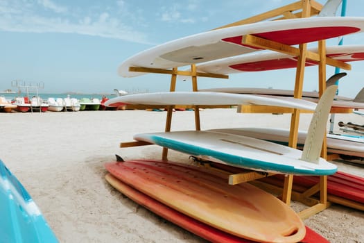 Surfboards stacked on the rack on a beach, close up