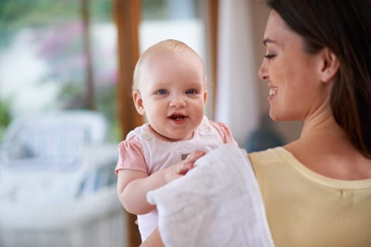 Mommas got you. a mother holding her baby girl at home