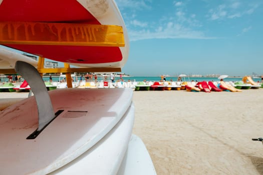 Surfboards stacked on the rack on a beach, close up