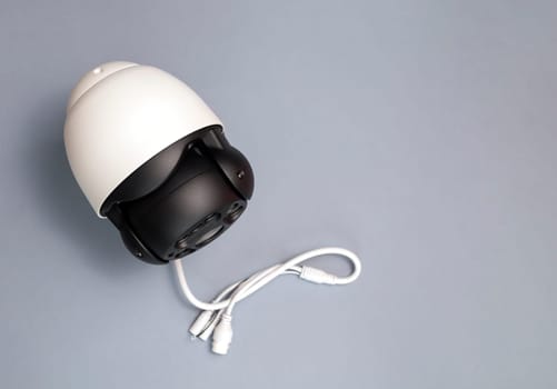 IP Smart Outdoor Security Camera On Gray Background. Smart Home, House Surveillance, System With Optical Zoom, Water Proof Cover, Facial Recognition. Horizontal plane, Copy Space For Text.