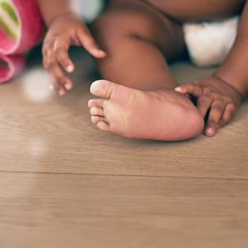 Closeup of baby, kids and feet with toes on wooden floor, home or nursery room mockup. Young infant children, foot and healthy development of growth, lifestyle or care of cute, small and growing body.
