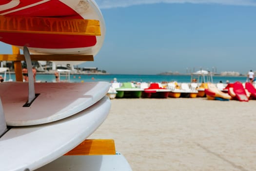 Surfboards stacked on the rack on a beach, close up