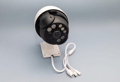 Surveillance IP Wireless Camera On Gray Background. Security Equipment For Smart Home With Online Remote App Monitoring. Protection Of Private Residential Building. Horizontal plane.High Quality Photo