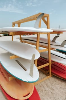 Surfboards stacked on the rack on a beach, close up