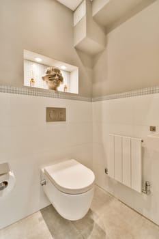 a white toilet in a bathroom with tile on the walls and ceiling above it is an image of a man's face