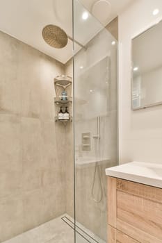 a bathroom with a glass shower door and wooden vanity in the corner next to the walk - in shower stall