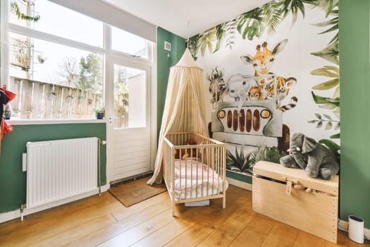 a baby's room with animals on the wallpaper and wooden furniture, including a cribe bed