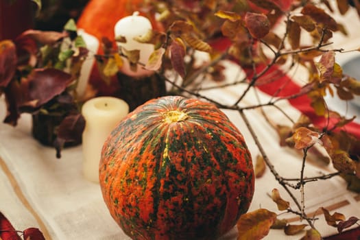 Autumn background with pumpkin close up on table