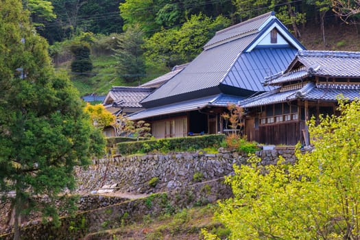 Traditional Japanese house on stone terrace in mountain village. High quality photo