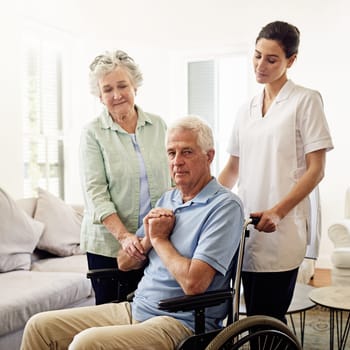 Portrait of old man in wheelchair with wife and caregiver at nursing home for disability and rehabilitation. Healthcare, recovery and senior couple with nurse together in house or retirement center