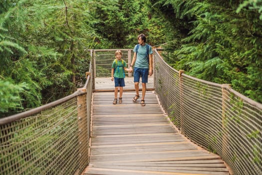 father and son tourists in Rope bridge in Yildiz Park. Besiktas, Istanbul, Turkey. Turkiye. Traveling with kids concept.